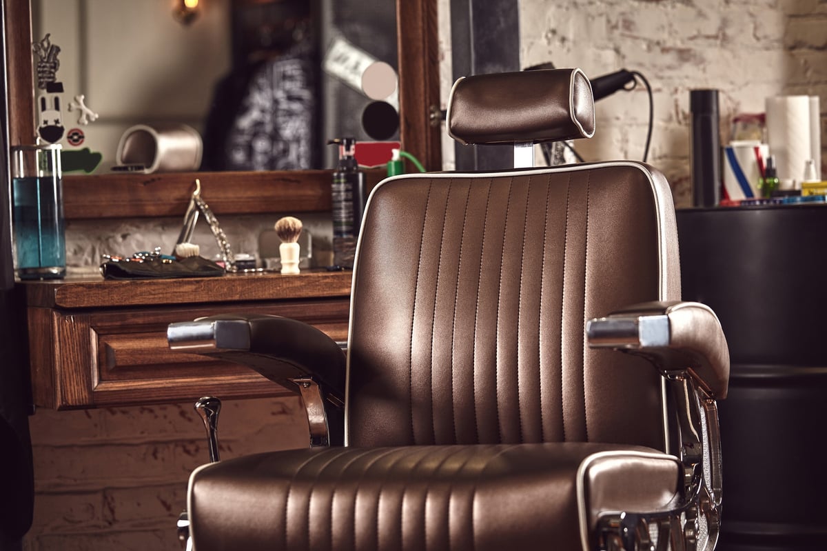 Barbershop brown armchair. Modern hairdresser and hair salon, barber shop for men.