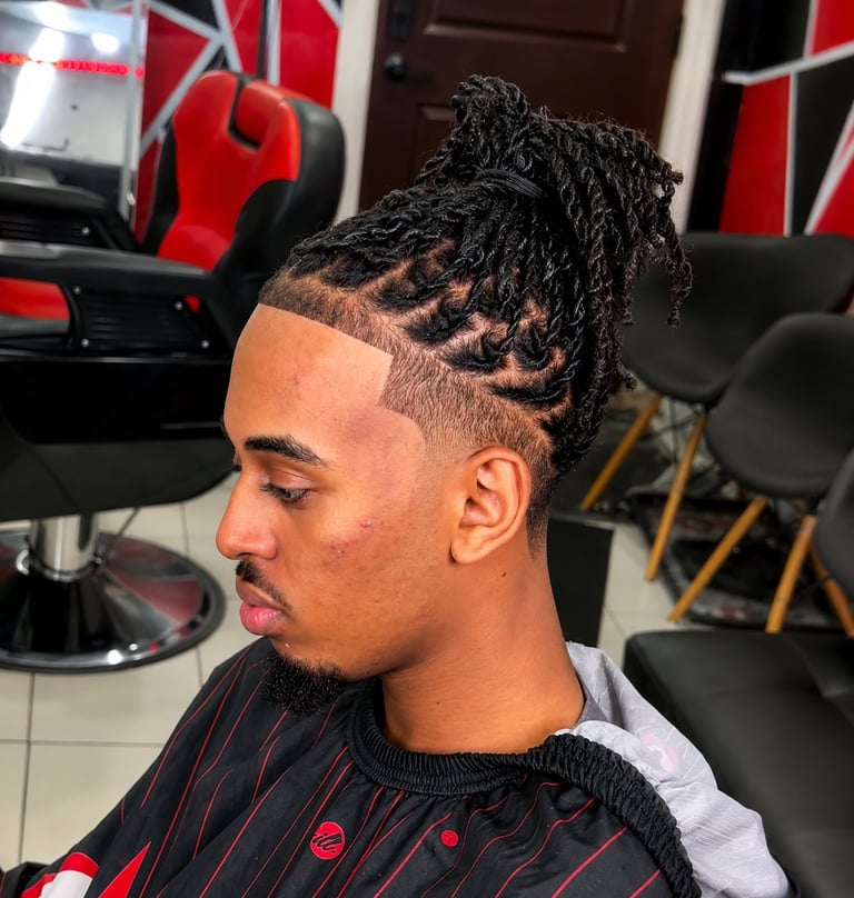Man with fade haircut and black twisted top knot